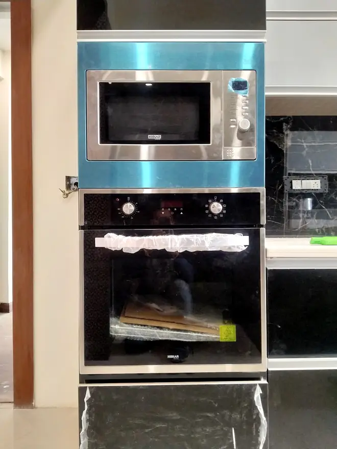 Built-in microwave and oven stacked in a kitchen column unit