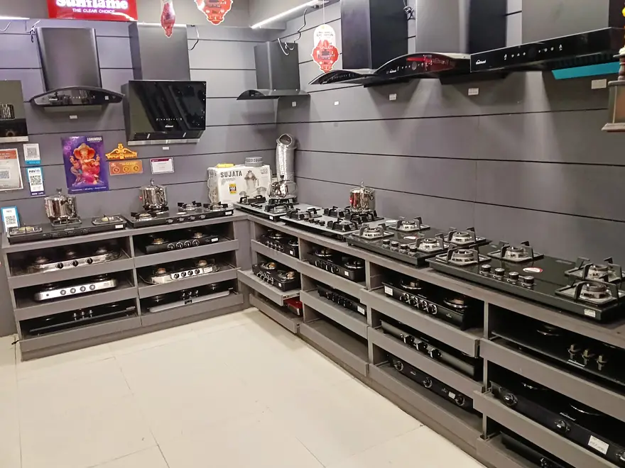 Tiered racks of gas hobs along a grey wall with chimneys mounted above them
