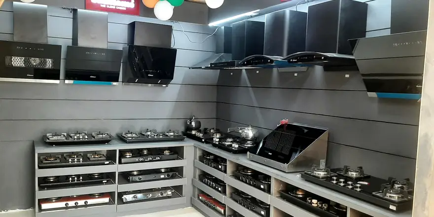 A long run of hobs on stepped shelves under strip lighting